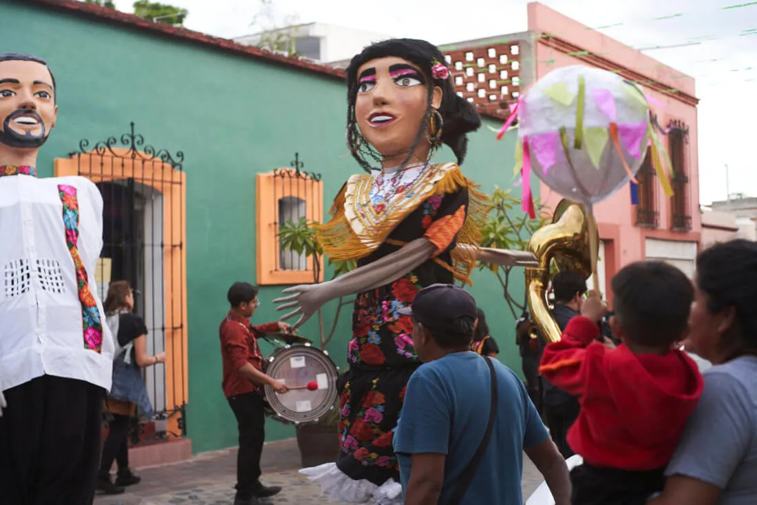 Two dancing monos de calenda in colorful street